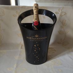 a bottle of champagne in a black bucket