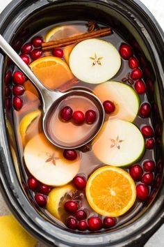 cranberry apple cider punch in an instant pot with oranges and apples