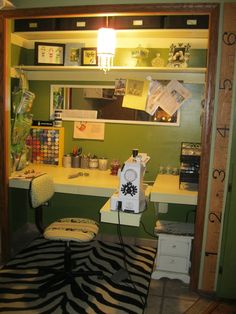 a room with a zebra rug, desk and shelves on the wall above it that have various items on top of them