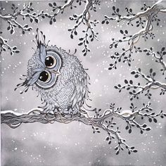 an owl sitting on top of a tree branch with snow falling off it's branches