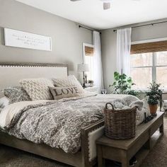 a bedroom with a large bed and lots of pillows