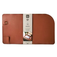 a brown leather desk pad with a notepad attached to it