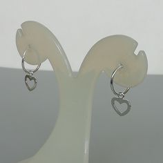 A PAIR of sterling silver hoops. Comes with a detachable heart charm. The charm is multipurpose and can be used with a neck or bracelet chain too. Dimension: Hoop- 14 x 1.5 mm Heart: 11 x 11 mm Price listed is for a PAIR of hoops. These earrings are made of 925 hypoallergenic sterling silver and comes with a 925 stamp. Can be packaged in a gift box. I can include a personal message from you if needed You are welcome to contact me at... bhavnakwintra1956@gmail.com For more beautiful pieces from m Silver Heart Charm Huggie Earrings, Silver Huggie Earrings With Heart Charm, Silver Sterling Heart Charm Huggie Earrings, Silver Huggie Earrings With Heart Charm For Gift, Silver Sterling Huggie Earrings With Heart Charm, Silver Small Hoop Earrings With Heart Charm, Silver Hoop Earrings With Heart Charm, Dainty Sterling Silver Hoop Earrings With Heart Charm, Small Hoop Sterling Silver Heart Earrings Hypoallergenic