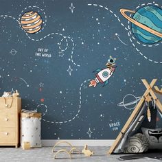 a child's room with space themed wallpaper and wooden toys on the floor