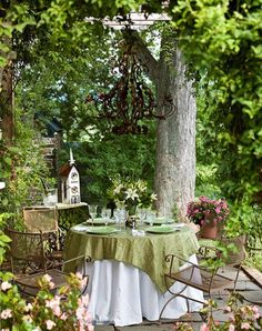 an outdoor dining area with table and chairs