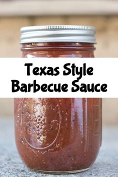 a jar filled with barbecue sauce sitting on top of a table