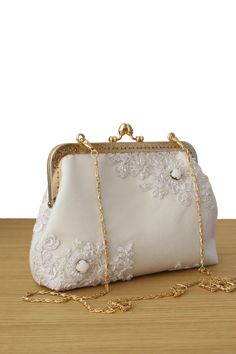 This rare lace clutch purse for Bride made in France. The White Wedding clutch bag and Evening clutch bags are a unique piece of the Olga's Luxury Creation. They will sublimate you during your galas, parties and events. Elegance, style and originality are the key parts of these creations. The use of quality materials, advanced know-how are essential values to offer you the best creations. What are you waiting for to sublimate yourself and being original, come to discover our large collection of evening bags. 100% handmade bag. Inside French  silk/coton This bag  closed with Kiss-lock frame. - Height5,2"  - Length 9"  - Depth2,3"  - Chain  35" - Golden hardware Frame 7" Made in France Elegant Rectangular Evening Bag For Ceremony, Elegant White Handheld Pouch, Rectangular Removable Pouch For Wedding, Elegant Pearl Embroidered Pouch, Elegant White Evening Pouch, Elegant Wedding Clutch With Removable Pouch, Elegant Pouch Bag For Ceremony, Elegant Pouch Bag For Ceremonies, Elegant Ceremony Pouch Bag