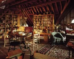 a room filled with lots of books and furniture