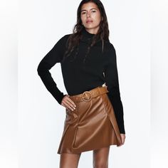 High Waisted Skirt With Self Belt Pleat Detail Back Hidden Inseam Zip Closure Whiskey Fall Belted Mini Skirt, Belted Mini Skirt For Fall, Fall Mini Skirt With Belt, Fall Brown Belted Skirt, Chic Fall Mini Skirt, Chic Winter Mini Skirt For Workwear, Belted Mini Skirt For Fall Night Out, Belted Mini Skirt For Night Out In Fall, Fall Season Belted Mini Skirt For Night Out