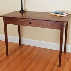 a wooden table with a lamp on top of it