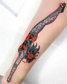 a woman's leg with a tattoo on it and a flower in the middle