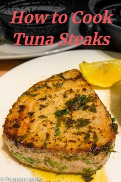 how to cook tuna steaks on a plate with lemon wedges and parsley