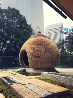 an outdoor sculpture with moss growing on it