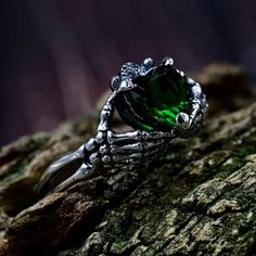 a green ring sitting on top of a tree branch