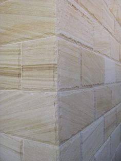 the corner of a wall made out of plywood planks is shown in this image