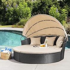 an outdoor day bed next to a swimming pool