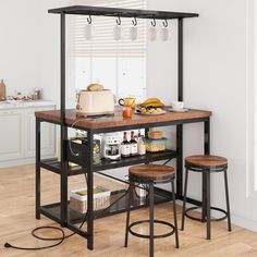 a kitchen table with two stools next to it and food on the counter top