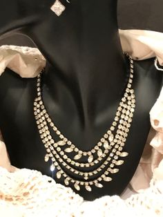 "This is a stunning, vintage, rhinestone, bib necklace. The necklace is in excellent, vintage condition, and is unique and versatile. These necklaces are becoming more and more difficult to find in this condition. Each rhinestone is set, not glued. This one is not missing any stones, and all stones are clear. The necklace is 17\" long, and weighs 52g. The necklace is not signed, but beautifully made." Vintage Sparkling Stones Necklaces For Party, Vintage Diamond Necklace With 17 Jewels For Evening, Vintage Rhinestone Necklace For Vintage Events, Vintage Necklaces With Sparkling Stones For Evening, Vintage Crystal Rhinestone Necklace For Party, Vintage Evening Necklaces With Sparkling Stones, Vintage Crystal Rhinestone Necklace, Vintage Rhinestone Bridal Necklace For Party, Vintage Crystal Necklace With Sparkling Stones