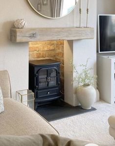 a living room with a fireplace and mirror on the wall