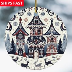 a christmas ornament with an image of a house and reindeers on it