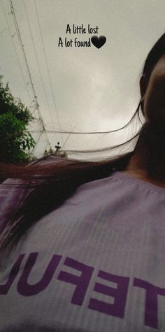 a woman with long hair wearing a purple shirt