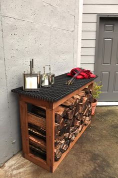 a table made out of firewood with candles on top