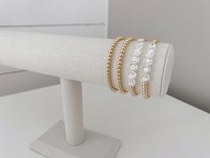 one name bracelet made with 4mm 14k gold plated beads bracelets are made on a durable stretch elastic cord please refer to our sizing guide before purchasing Name Bracelet, White Rose Gold, Bracelet Making, Wrap Bracelet, Gold Bracelet, Gold Plate, Plating, Rose Gold, Beaded Bracelets