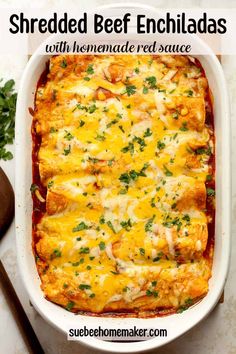 shredded beef enchiladas with homemade red sauce in a casserole dish