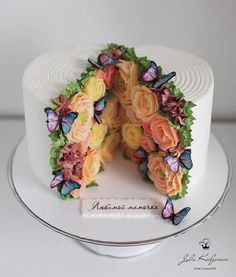 there is a cake decorated with flowers and butterflies