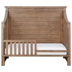 a wooden crib with a mattress on the bottom and side rails, against a white background