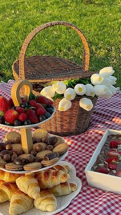 a table topped with lots of different types of pastries and fruit on top of plates