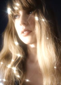 a woman with long blonde hair and lights on her face