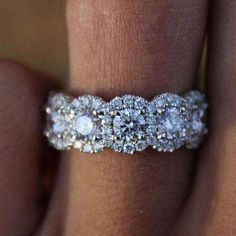 a woman's hand with a diamond ring on it