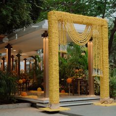 an outdoor wedding setup with yellow flowers and greenery