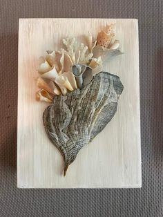 a piece of wood with sea shells on it