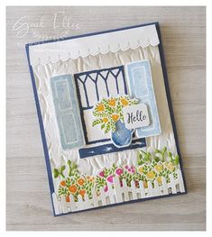 a handmade card with an image of a window and flowers on the outside, which reads hello