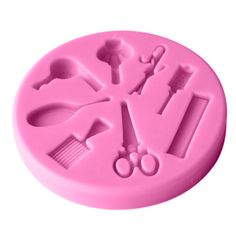 a pink plastic mold that has various tools on it