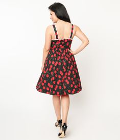 This lovely 1950s style pinafore swing dress is crafted in a gorgeous black woven stretch fabric with bright red cherries throughout. The sleeveless straps are accented with adorable red faux buttons trailing onto the bodice, while the swing skirt is outfitted with side pockets.Available in sizes XS-5X while supplies last. Vintage Fitted Dress With Adjustable Straps, Retro Sleeveless Cherry Print Dresses, Retro Fitted Sleeveless Pinafore Dress, Spring Black Pinup Dress, Spring Pinup Black Dress, Red Rockabilly Summer Dress, Sleeveless Black Rockabilly Dress, Black Sleeveless Rockabilly Dress, Red Sleeveless Rockabilly Dress