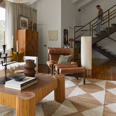 a living room filled with furniture and a stair case