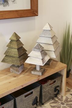 three wooden christmas trees sitting on top of a table