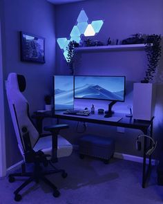 a computer desk with two monitors and a chair in front of it, lit up by blue lights