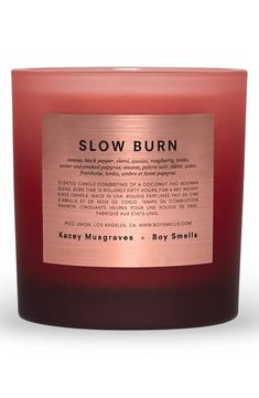 a candle that reads slow burn on the front and side, with a gold label