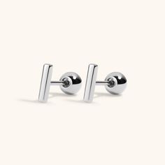 Our tiny bar stud earrings, now available in implant grade titanium for 24/7 waterproof, sweatproof, lifeproof wear. Graceful and elegant, these tiny staple size studs are like a classic Little Black Dress - a foundation piece for your ear stack - and an instant everyday classic. Also available in solid 14k gold and as a titanium flat back for cartilage piercings. SPECS & SIZING Solid implant grade titanium Gold version is coated in 18k gold PVD Plating 6mm tall x 1mm wide 20G post, 6mm wearable Ear Bar, Classic Little Black Dress, Cartilage Piercings, Cartilage Earrings Stud, Ear Party, Bar Stud Earrings, Foundation Piecing, Ear Stack, Bar Studs