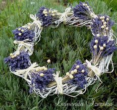 a wreath made out of lavender flowers in the grass