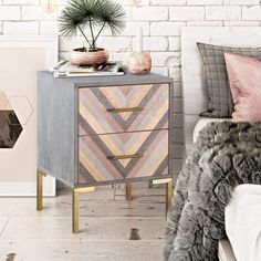 an image of a bedroom setting with furniture and decor on it's side table