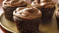 cupcakes with chocolate frosting on a gold plate