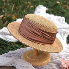 Add a touch of classic charm to your summer wardrobe with these elegant straw boater hats. Crafted from high-quality natural straw, these hats feature a wide brim that provides excellent sun protection while maintaining a stylish look. The hats are adorned with a soft, ruched fabric band in sophisticated colors, including a gentle sage green and a vibrant mustard yellow, allowing you to choose a hue that complements your outfit. Key Features: Made from high-quality natural straw Wide brim for op