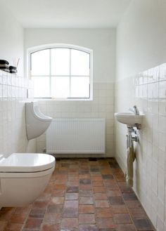 a bathroom with a toilet, sink and bathtub