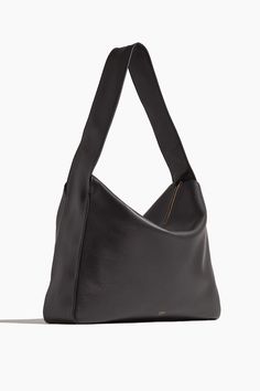 The Khaite Elena Large Shoulder Bag is a piece you'll have for years to come. This shoulder bag features a sleek silhouette with a classic zip top in pebbled leather. Shoulder bag Zip top Shoulder strap Length:17.5 in/44.5 cm Width:3.5 in/8.9 cm Height:14 in/35.6 cm Pebbled leather 100% Calfskin Sleek Double Handle Shoulder Bag With Smooth Grain, Everyday Structured Shoulder Bag With Smooth Grain, Structured Shoulder Bag With Smooth Grain For Daily Use, Sleek Shoulder Bag With Top Handle And Smooth Grain, Sleek Top Handle Shoulder Bag With Smooth Grain, Minimalist Leather Bag With Gold-tone Hardware, Black Structured Bag With Smooth Grain, Minimalist Textured Leather Formal Bags, Formal Minimalist Textured Leather Bag