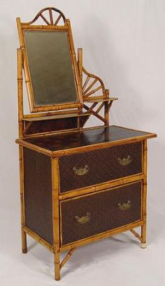 an antique bamboo vanity with mirror on top and drawers in the bottom drawer, against a white background